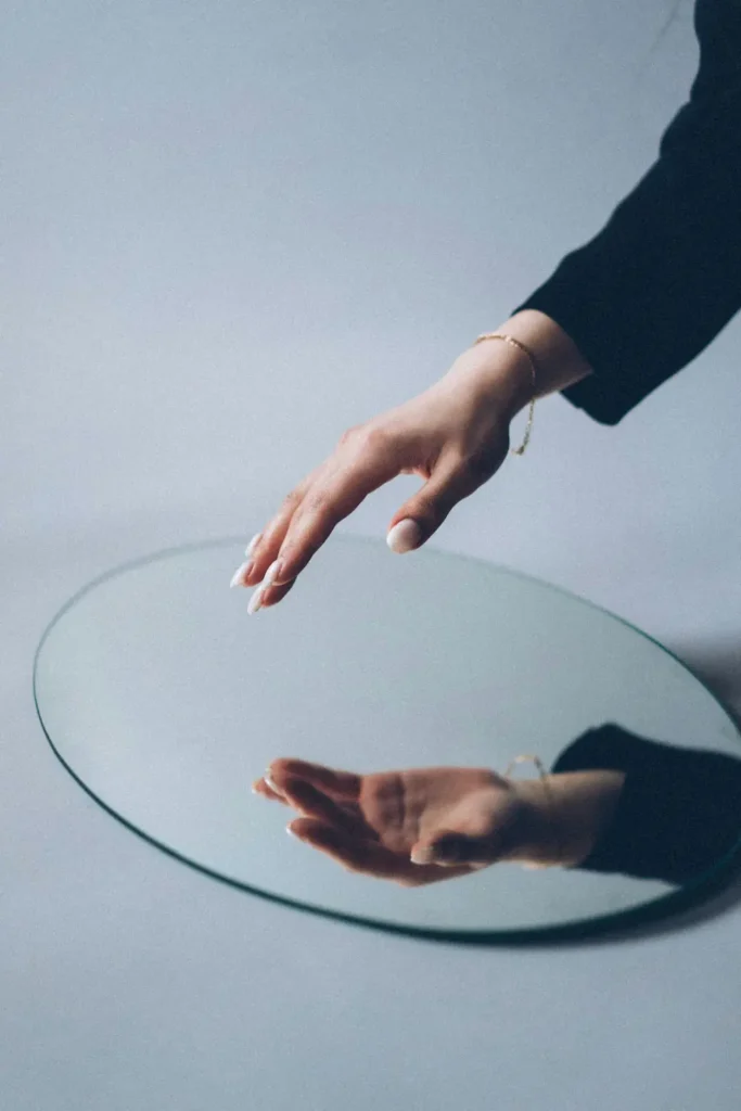 mirror Woman's hand and its reflection in the mirror